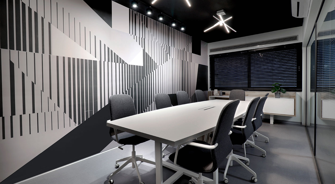 Modern meeting room at Lancom with geometric wall design and conference table.