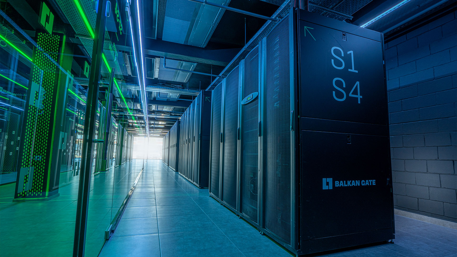 Server room inside Balkan Gate Thessaloniki Data Center with illuminated racks and cooling infrastructure.